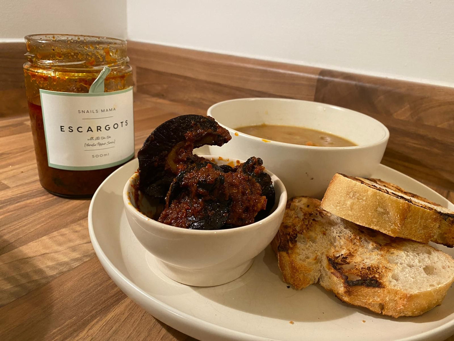 A jar of 3 ready to eat African jumbo snails in a hot pepper sauce 🌶 🌶🌶🌶